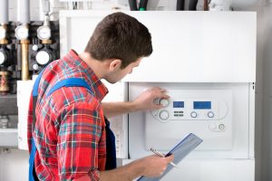 Technician servicing heating boiler