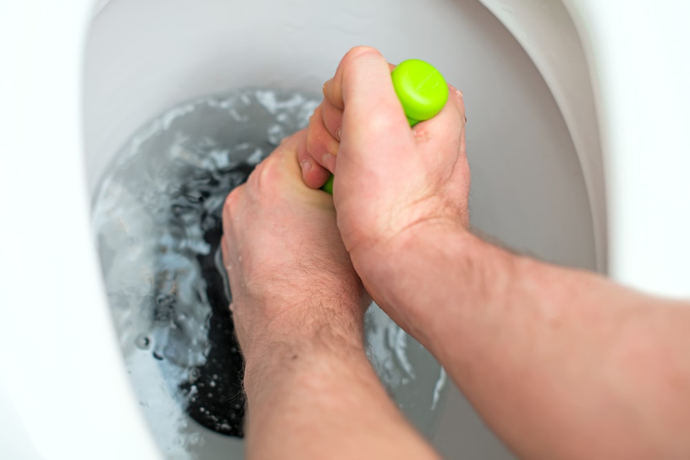 Plumber Using Plumber In Toilet