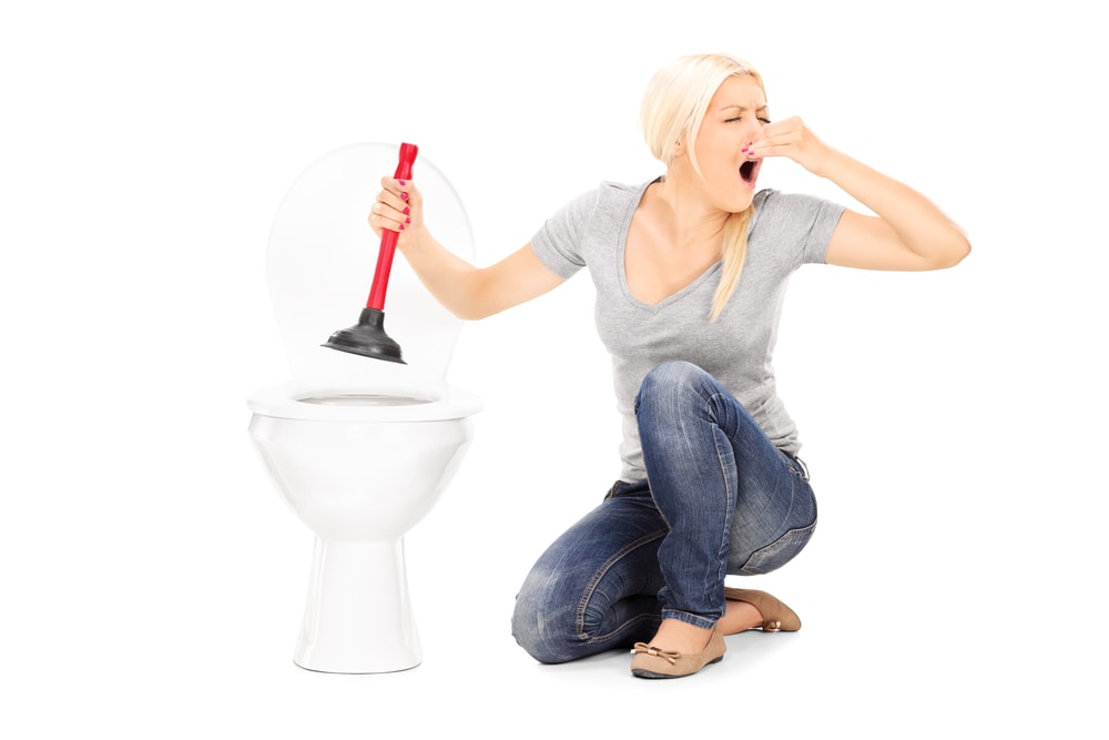 Woman Plunging Stinky Clogged Toilet
