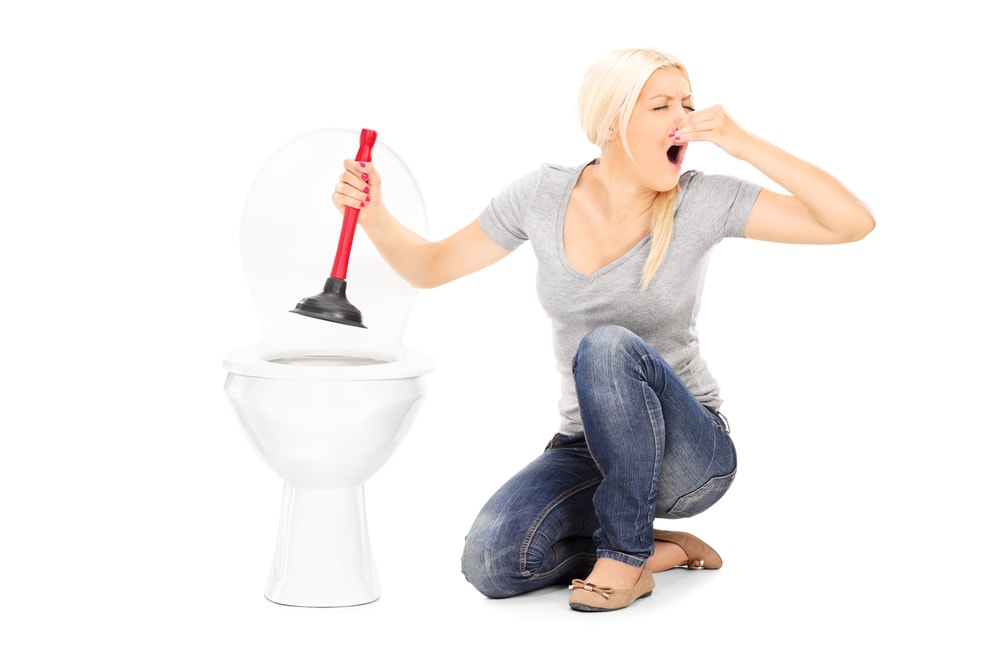 Woman Plunging Stinky Toilet Caliente Plumbing